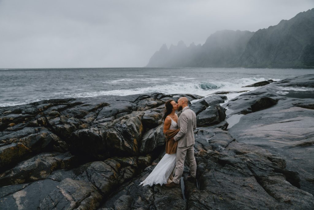 Moody Norway elopement on Senja Island. Having a stormy kiss. By Christin Eide Photography.