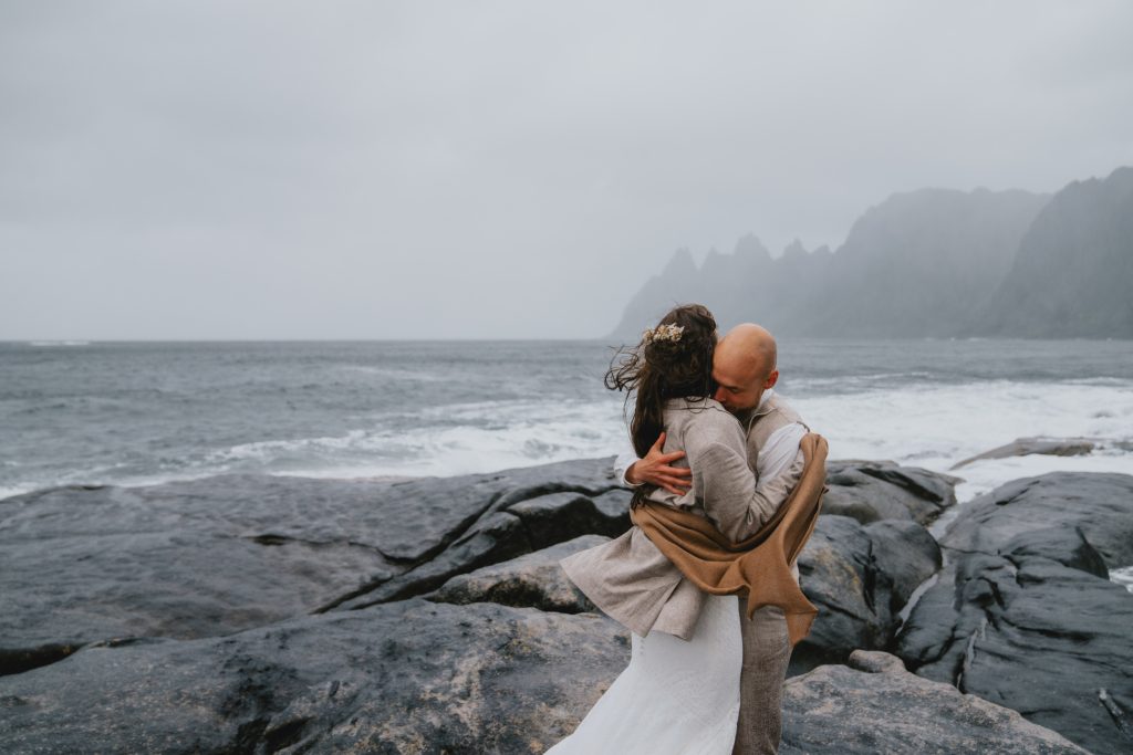 Moody Norway elopement on Senja Island. Stormy hug. By Christin Eide Photography.