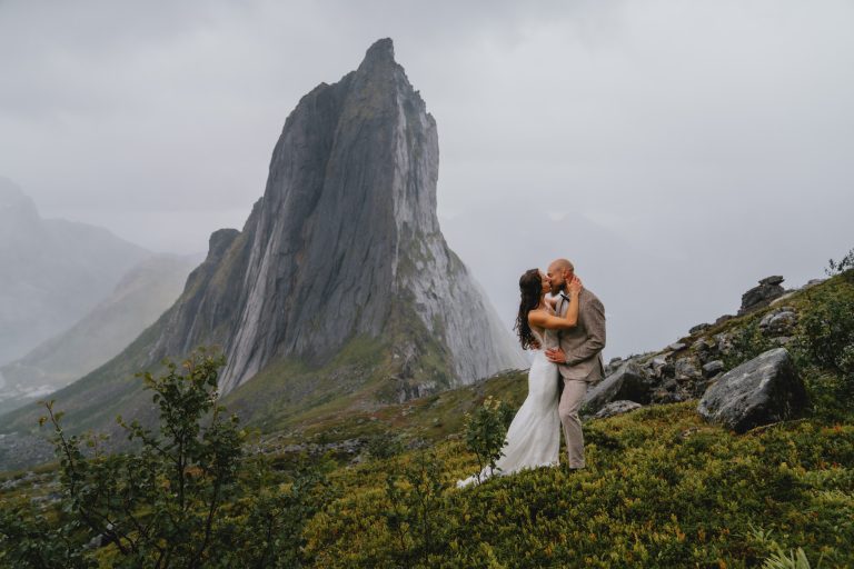 Moody Norway elopement on Senja island. Having an intimate moment covered in fog and rain. By Christin Eide Photography