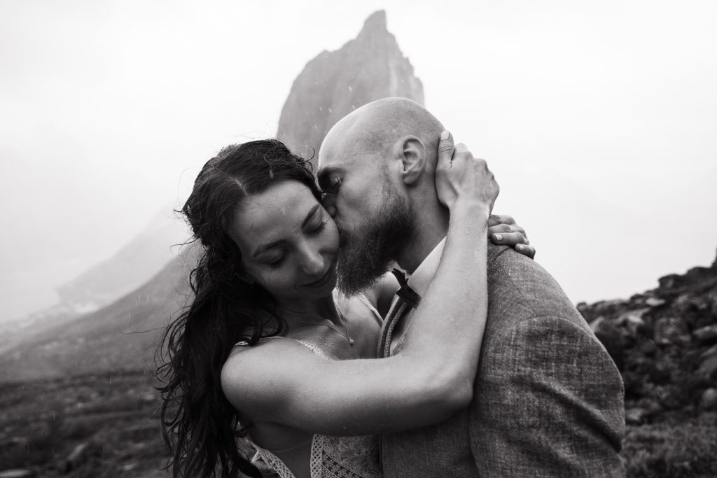 Moody Norway elopement on Senja Island. Intimate kiss. By Christin Eide Photography.