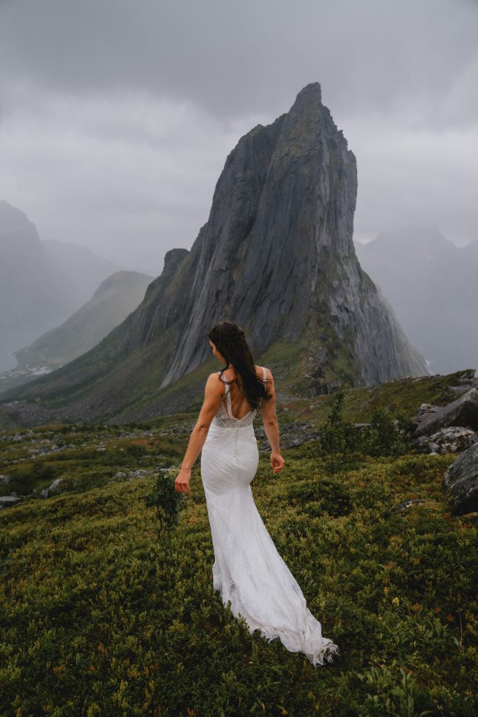 Moody Norway elopement on Senja Island. Bride walking away. By Christin Eide Photography.