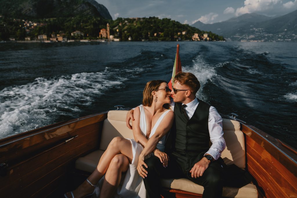 How to choose your elopement photographer. Sharing a kiss in a Riva on Lake Como, Italy. By Christin Eide Photography